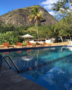 a swimming pool with a mountain in the background at Apt Flat 225 Condomínio Pedra do Rodeadouro in Bonito