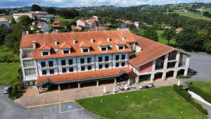 an overhead view of a large building with an orange roof at Hotel Cristina in Noreña