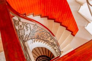 a spiral staircase with a red and white stair case at Grand Victoria Boutique Hotel in Loja