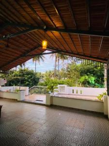 an empty building with a view of a garden at Pal's Cottage in Mysore