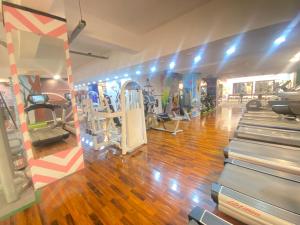 a gym with treadmills and machines in a room at Viceroy Luxury Hotel Apartments Islamabad in Islamabad