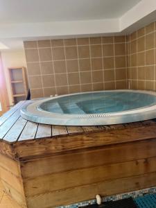 a jacuzzi tub on a wooden platform in a room at Arc 1950 Ap 171 Résidence les Sources de Marie in Bourg-Saint-Maurice