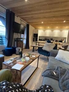 a living room with a couch and a table at Arc 1950 Ap 171 Résidence les Sources de Marie in Bourg-Saint-Maurice