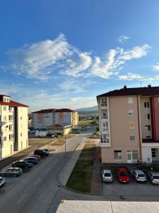 a city street with cars parked in a parking lot at Apartment Sunny day in Livno