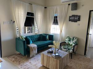 un soggiorno con divano blu e tavolino da caffè di Sir Frederick's Villa a Florence Hall