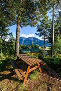 a wooden picnic table with a view of a mountain at Korsbakken Camping in Isfjorden