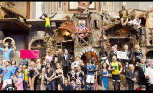 a group of people standing in front of a toy house at La dimora delle zite in Naples