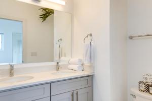 a white bathroom with two sinks and a mirror at Modern Denver Townhome with Rooftop Terrace! in Denver +36 photos