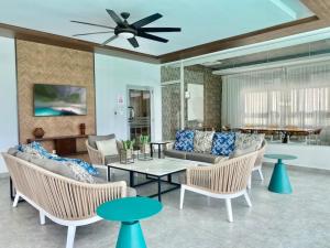 a living room with a couch and chairs and a ceiling fan at Elegant City Center Condo in Santo Domingo
