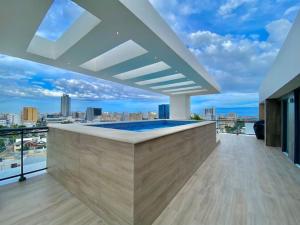 a pool on the roof of a building with a view at Lovely City Center Condo in Los Prados