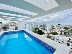 a swimming pool on the roof of a building at Lovely City Center Condo in Los Prados