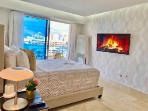 a bedroom with a bed with a fireplace on the wall at Great Centric Apt, Pool, in Santo Domingo