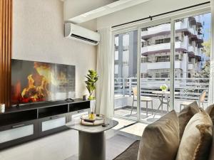 a living room with a couch and a large window at Beautiful Condo in Bella Vista in Los Prados
