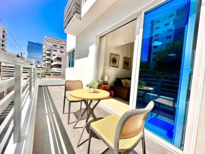 a balcony with a table and chairs on a building at Beautiful Condo in Bella Vista in Los Prados