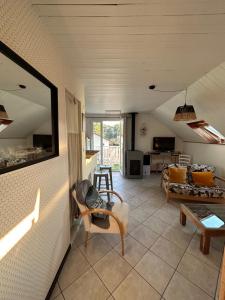 a living room with a couch and a table at Le Cosy Home Annecy in La Balme-de-Sillingy