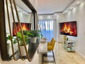 a living room with a fireplace and plants at Great Centric Apt, Pool, in Santo Domingo