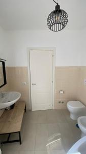 a bathroom with a sink and a toilet and a mirror at I giardini del borgo in Vico nel Lazio