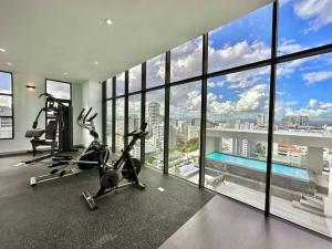 a gym with two exercise bikes and a large window at Stunning City Center Condo in Los Prados