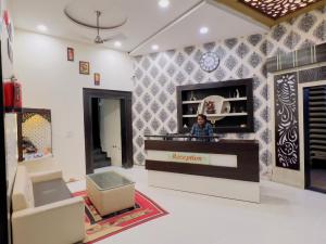 a woman standing at the cash register of a store at ALOK RESIDENCY in Satna