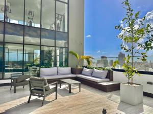 a living room with a couch and a table at Stunning City Center Condo in Los Prados