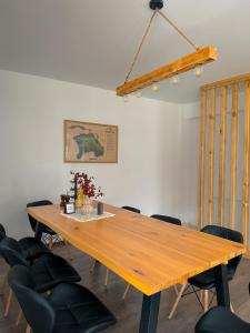a large wooden table in a room with chairs at Pensiunea Oacheș in Sălaşu de Sus