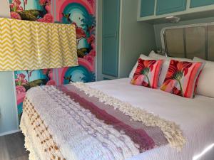 a bedroom with a bed with a colorful wall at Motel Chelsea in Chelsea