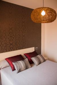 a bedroom with a bed with two pillows on it at Acogedor adosado muy cerca de la playa in Almazora