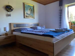 a bedroom with a large bed with a wooden frame at Haus Sperleiten in Abtenau