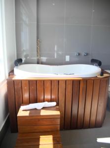 a bathroom with a bath tub with a sink at Hotel Black Inn Flamboyant in Goiânia