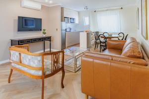 a living room with a couch and a dining room at Orly Suites in Santiago