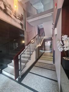 a hallway with stairs in a building with flowers at Warta LUX Apartment, self check-in 24h, free parking in Poznań