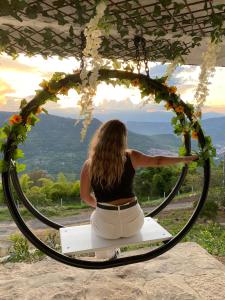 a woman sitting on a bench in a hoop at Esmeralda DELUXE in San Gil