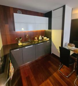 a kitchen with a sink and a table at Warta LUX Apartment, self check-in 24h, free parking in Poznań