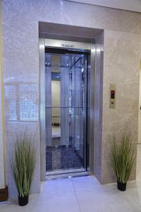 a revolving door in a building with two plants at Barbera Hotel in Istanbul