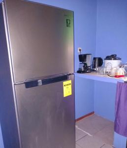 a stainless steel refrigerator in a kitchen with a counter at Bora Rent lodge in Bora Bora