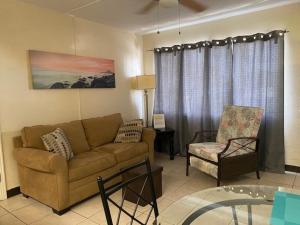 a living room with a couch and a chair at Beach Condo in St. Pete Beach