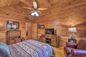 a bedroom with a bed and a flat screen tv at Dream Catcher Luxe Cabin with Large Deck and Mtn View in Sapphire