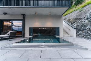 a swimming pool in the middle of a house at Arpuria l hidden luxury mountain home - ADULTS FRIENDLY in Sankt Anton am Arlberg