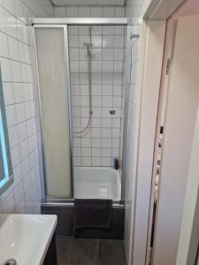 a bathroom with a shower and a tub and a sink at Ferienwohnung Schwarzwald friedhofstraße 13 in Obersasbach