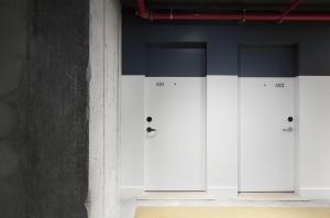 a row of white cabinets in a room at Boro Hotel in Queens