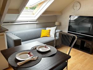 a small living room with a couch and a table at Room in Oss in Oss