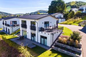 an aerial view of a white house at Ferienhaus Familienjuwel am Diemelsee in Diemelsee
