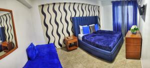Postel nebo postele na pokoji v ubytování Acuarium Suite Resort