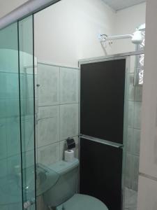 Un baño con inodoro y ducha de cristal. en Suítes em Cabo Frio, en Cabo Frío 33 fotos más