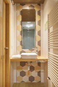 a bathroom with a sink and a mirror at Hotel Landaben in Pamplona