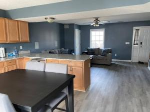 a kitchen and living room with a table and a couch at Luxury Townhome 2 Remodeled February 2021 in Bloomington