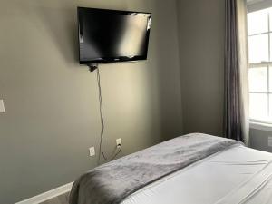 a bedroom with a flat screen tv on the wall at Luxury Townhome 2 Remodeled February 2021 in Bloomington