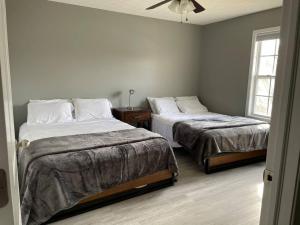 a bedroom with two beds and a ceiling fan at Luxury Townhome 1 Remodeled February 2021 in Bloomington