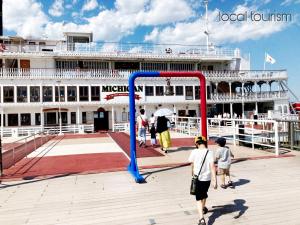 a group of people playing soccer on a pier with a cruise ship at WeeklyHouse Biwako Otsu - Vacation STAY 62243v in Otsu