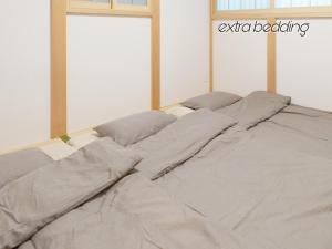 a bed in a white room with a window at WeeklyHouse Biwako Otsu - Vacation STAY 62243v in Otsu